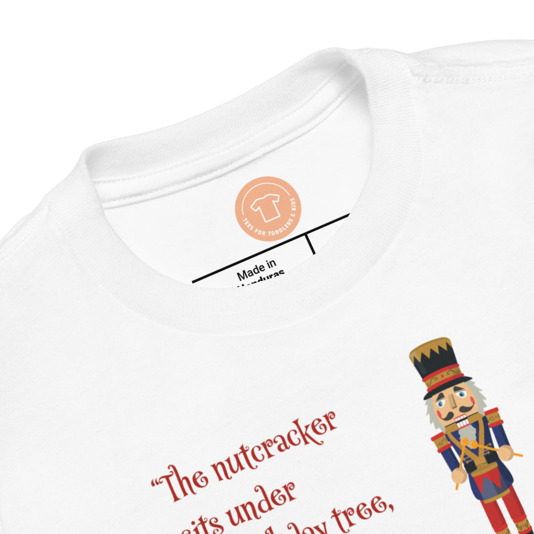 The Nutcracker Sits Under The Holiday Tree, A Guardian Of Childhood Stores. Feed Him Walnuts And He Will Crack Open a Tale... Short Sleeve T Shirts For Toddlers And Kids. - TeesForToddlersandKids -  t-shirt - christmas, holidays - the-nutcracker-sits-under-the-holiday-tree-a-guardian-of-childhood-stores-feed-him-walnuts-and-he-will-crack-open-a-tale-short-sleeve-t-shirts-for-toddlers-and-kids